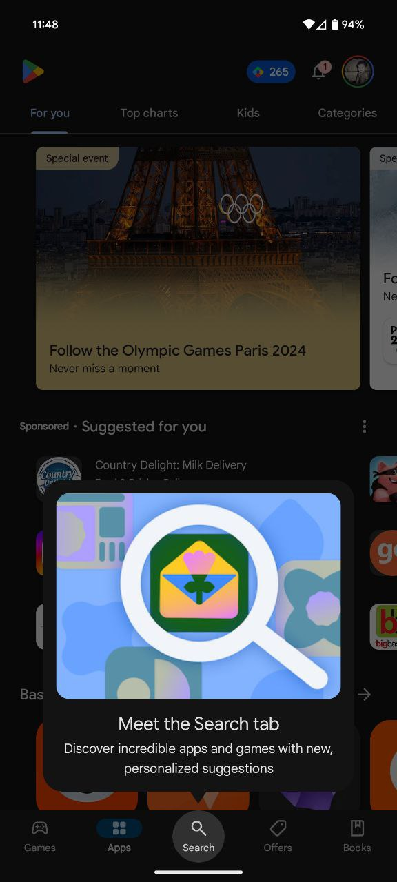The Google Play Store app with the search bar moved from its usual position in the top app bar to now being the central item in the bottom navigation. There is a coach mark titled "Meet the Search tab" that is supposed to make me feel there was actual thought behind this stupid change.