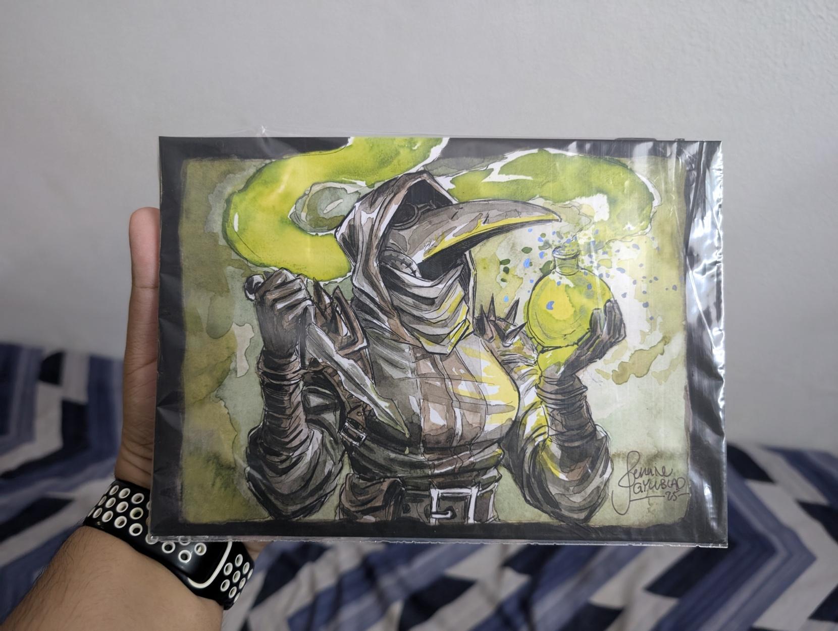 JenJen@mastodon.art's Plague Doctor print, still in its plastic bag. The character is female, wearing the signature Plague Doctor mask holding a potion bottle with a fuming green liquid in one hand and a dagger in the other