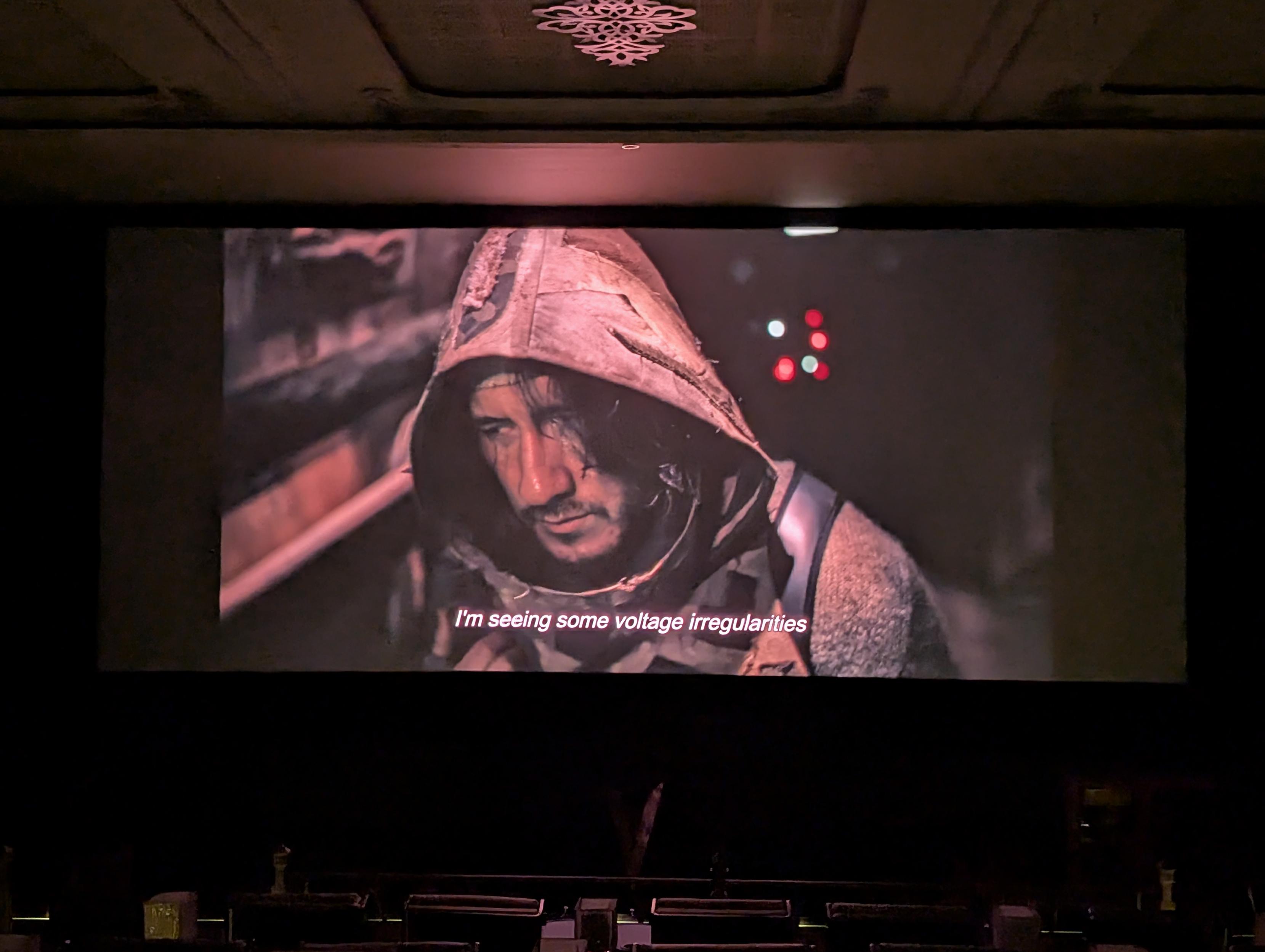 A scene from the movie Iron Lung with Markiplier looking down, listening intently.